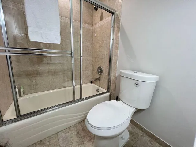 a bathroom with a toilet and a shower