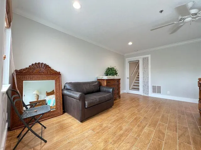 a living room with furniture and a mirror