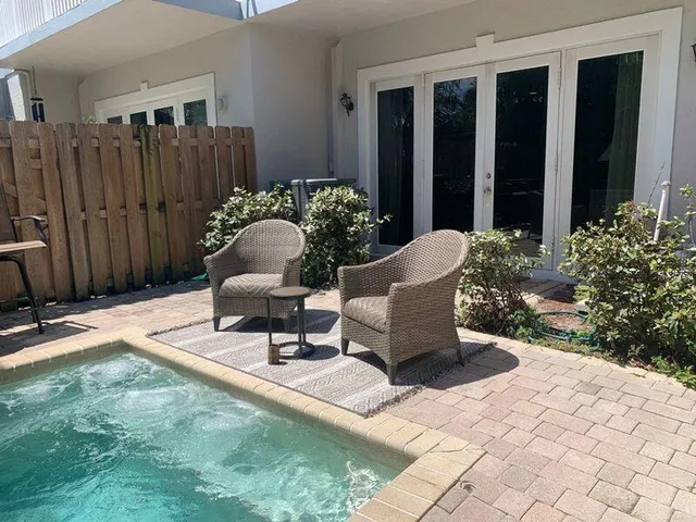 a view of a backyard with furniture and plants