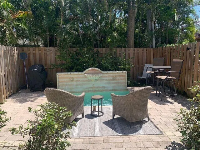 a view of a backyard with sitting area