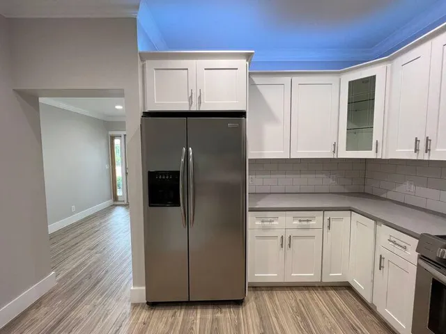 a kitchen with a refrigerator and cabinets