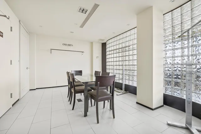 a view of a dining room with furniture and a window