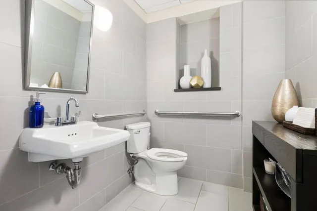 a bathroom with a sink toilet and mirror