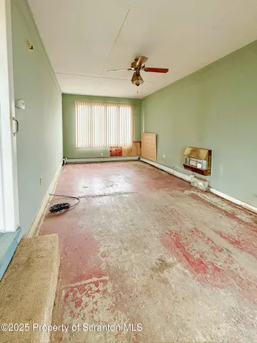 a room with water heater and wooden cabinet