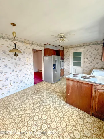 a kitchen with a sink a window and cabinets