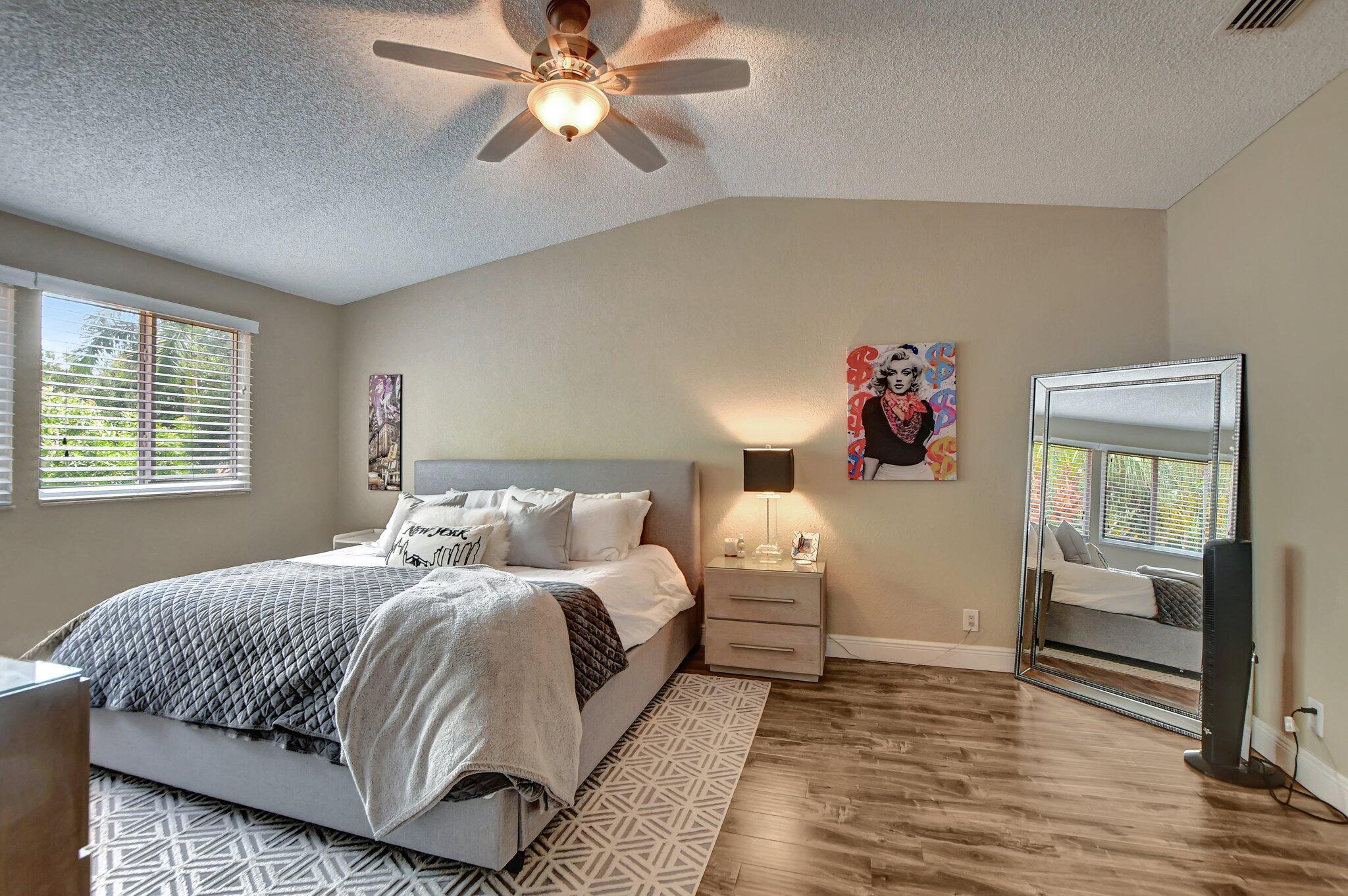 6682 Via Regina Boca Raton, FL 33433 - Photo 20 of 46 a bedroom with a bed and wooden floor