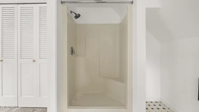 a view of a room with wooden floor and a window