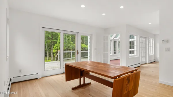 a view of work space with wooden floor and windows