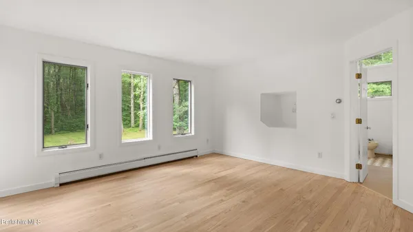 a bathroom with a toilet a sink and a window