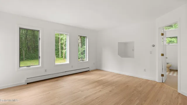 a bathroom with a toilet a sink and a window