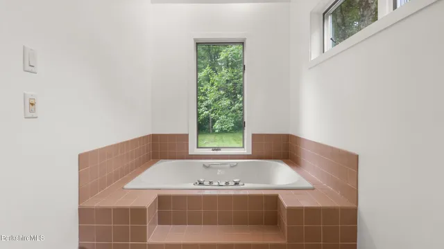 a view of an entryway with wooden floor and door