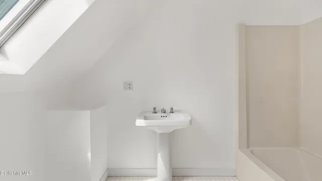 a bathroom with a sink a mirror and a bathtub