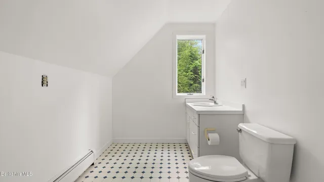 a bathroom with a toilet a window and a shower