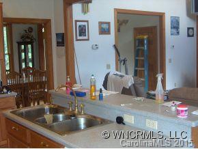 565 Jenkins Road Canton, NC 28716 - Photo 11 of 22 a kitchen with kitchen island a sink and a refrigerator
