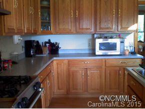 565 Jenkins Road Canton, NC 28716 - Photo 12 of 22 a kitchen with granite countertop a sink a stove and cabinets