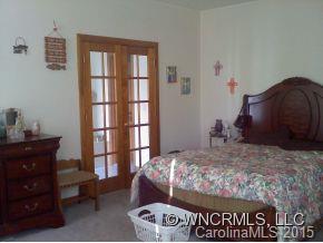 565 Jenkins Road Canton, NC 28716 - Photo 15 of 22 a bedroom with a bed and a window