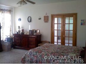 565 Jenkins Road Canton, NC 28716 - Photo 16 of 22 a bedroom with a bed and a dresser
