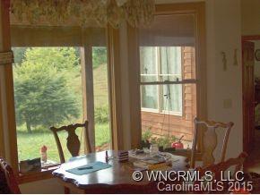 565 Jenkins Road Canton, NC 28716 - Photo 10 of 22 a view of a living room with a floor to ceiling window and wooden floor