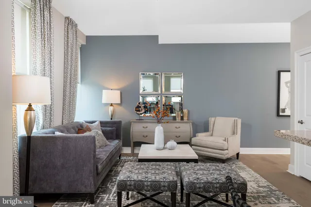 a living room with furniture and a dining table