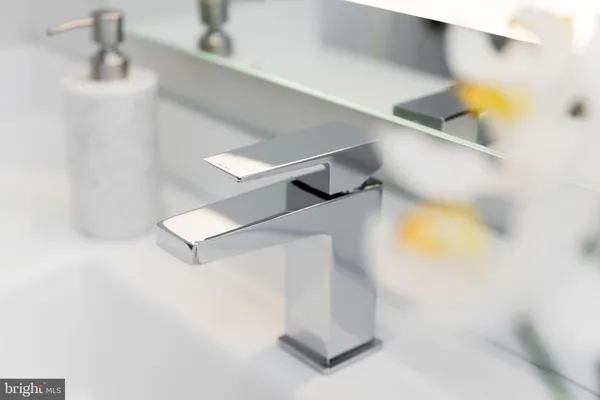 a bathroom with a sink a mirror and shower