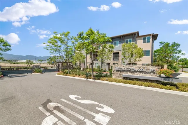 a view of a swimming pool with a lawn chairs under an umbrella