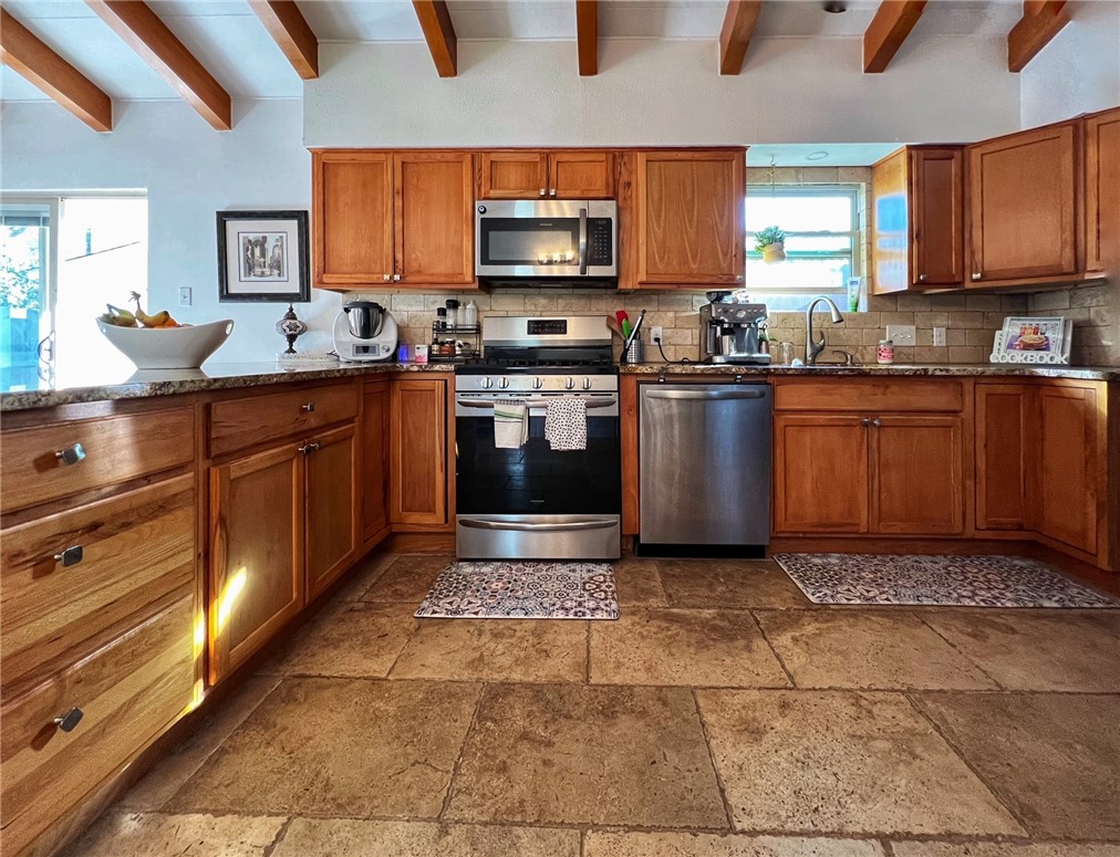 1807 Barbara Street Austin, TX 78757 - Photo 11 of 25 LARGE KITCHEN WITh STONE FLOORS. LOTS OF STORAGE. GAS COOKING. SEP LAUNDRY ROOM TO THE RIGHT WITH ACCESS TO GAR. STAINLESS APPLIANCES. REF INCLUDED