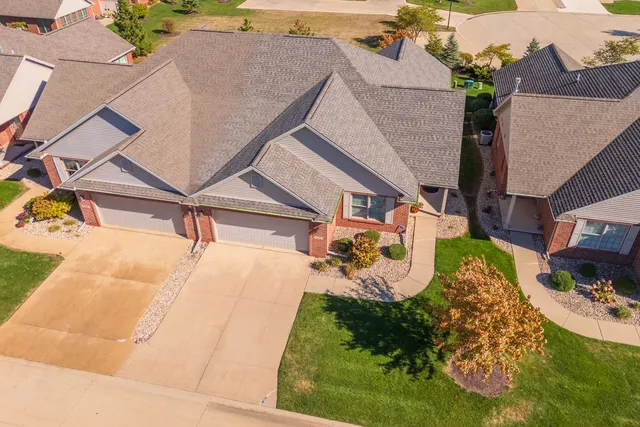 an aerial view of a house with a yard and potted plants