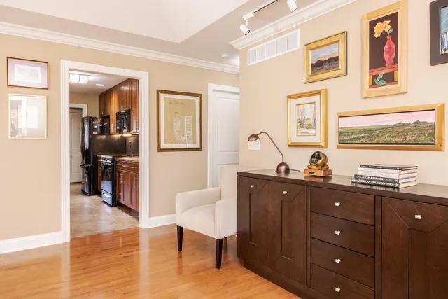 a spacious bedroom with a bed and a chandelier