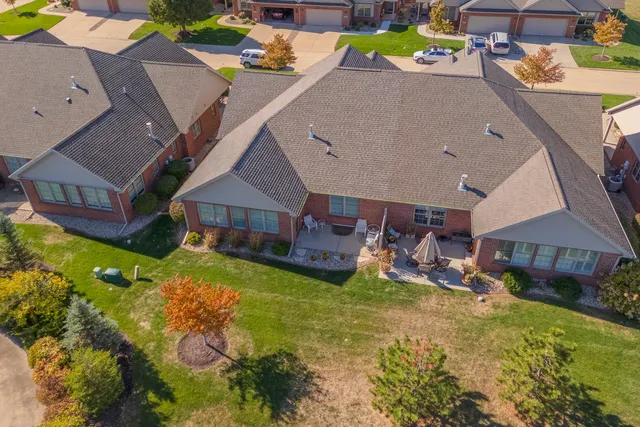 an aerial view of a house with a garden and swimming pool