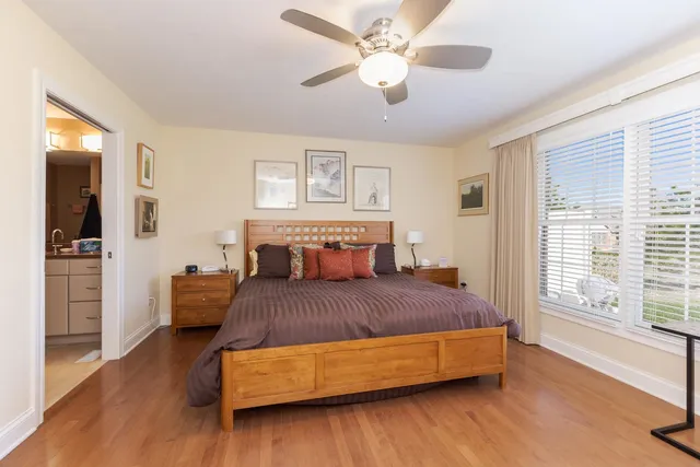 a bedroom with furniture and wooden floor