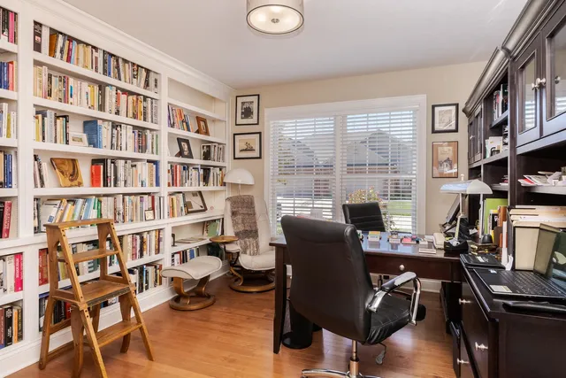 a dining room with fireplace furniture and a chandelier