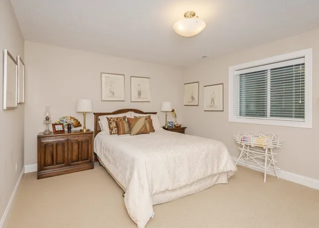 an aerial view of residential houses with outdoor space and trees