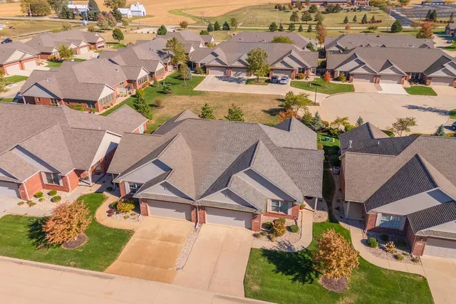 an aerial view of residential houses with outdoor space