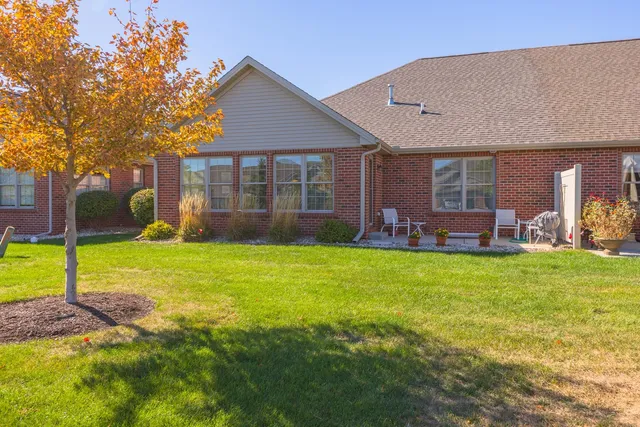 a front view of house with an outdoor space and seating