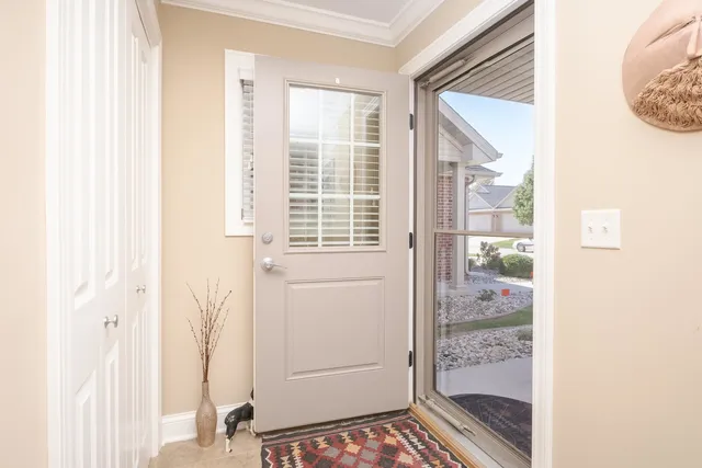 a living room with furniture a wooden floor and a large window