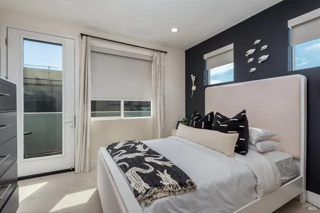 a bedroom with a bed and a mirror