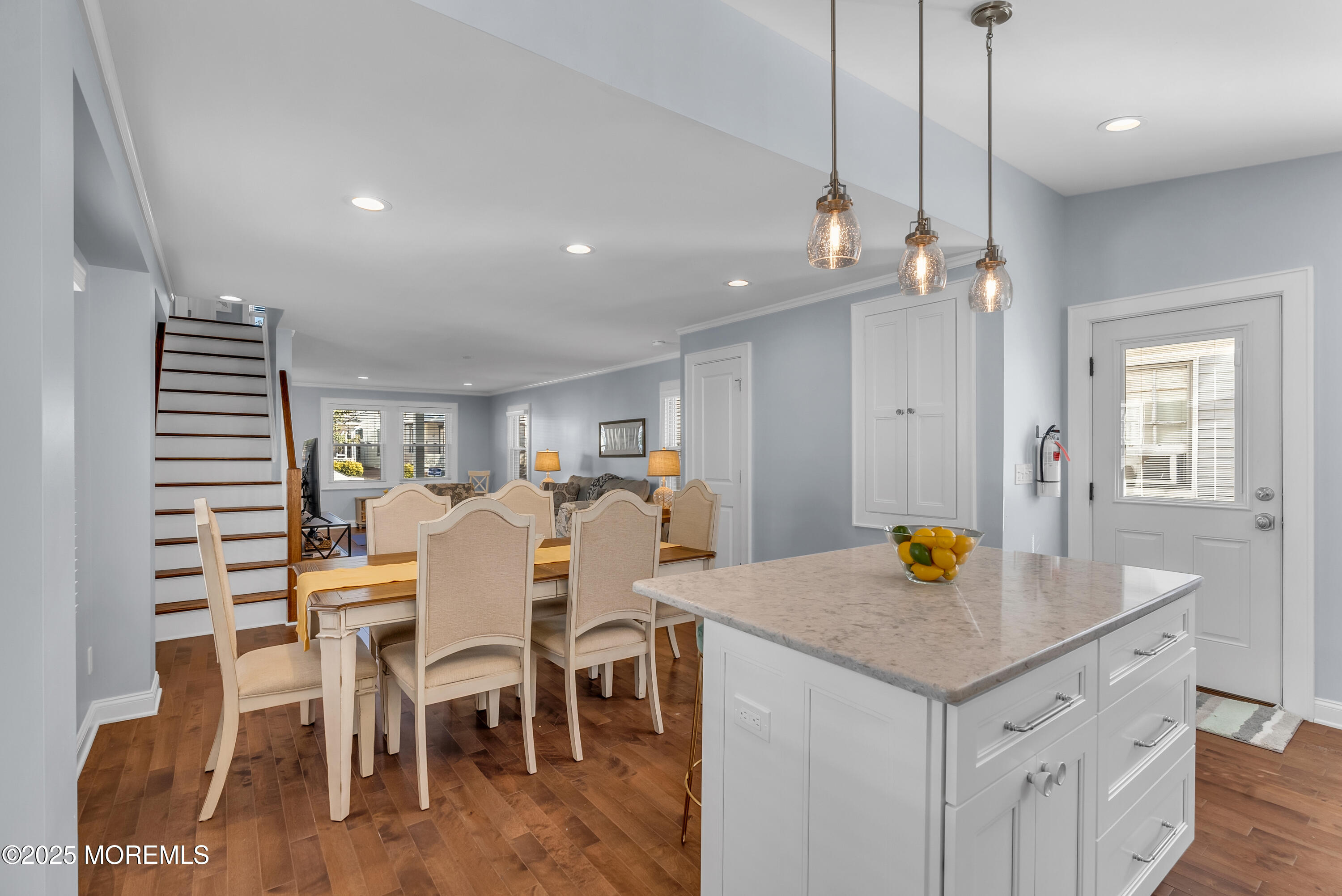 52 Embury Avenue Ocean Grove, NJ 07756 - Photo 14 of 88 a view of a dining room and livingroom with furniture wooden floor a rug a fireplace and a chandelier