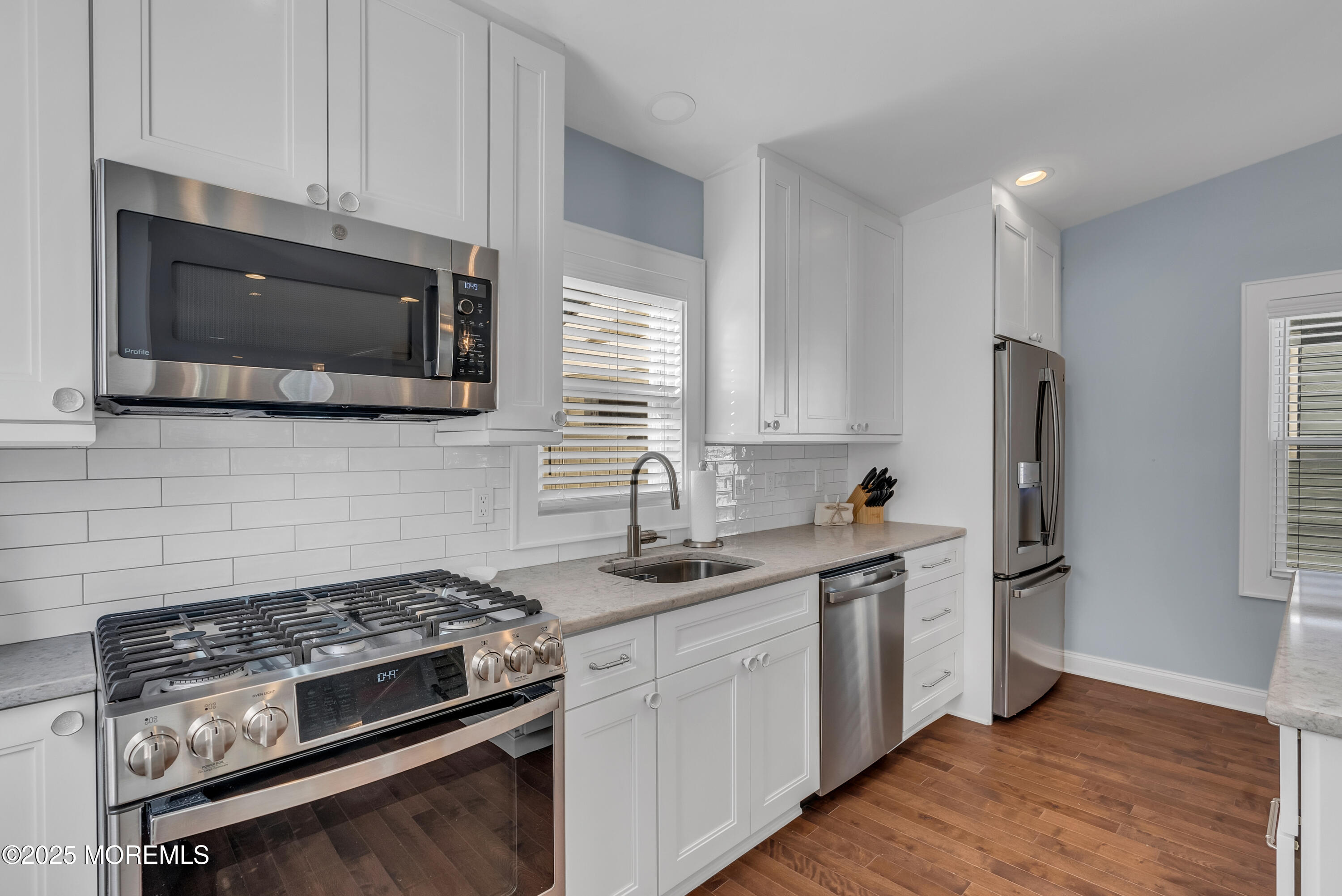 52 Embury Avenue Ocean Grove, NJ 07756 - Photo 18 of 88 a kitchen with stainless steel appliances a stove microwave and sink