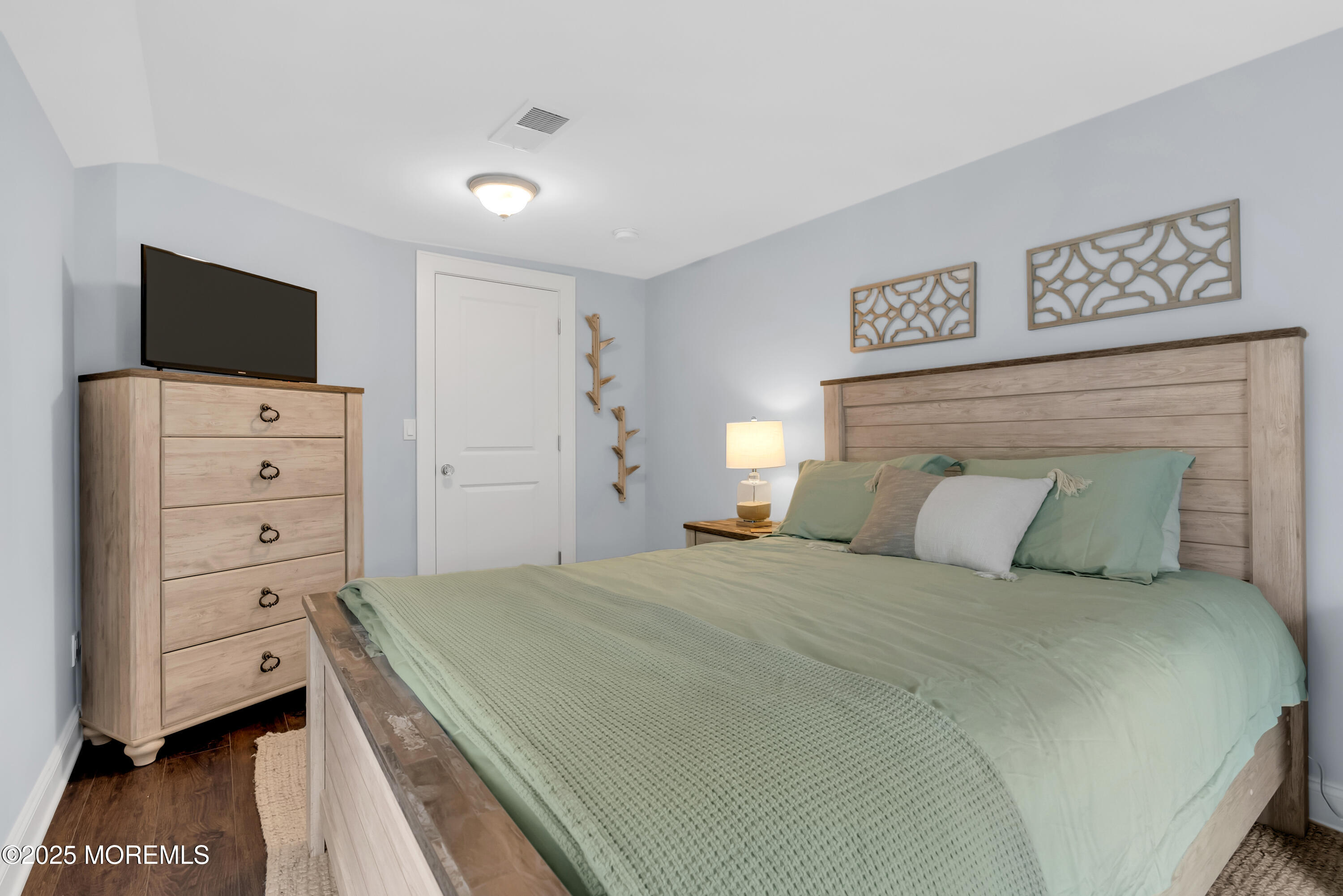 52 Embury Avenue Ocean Grove, NJ 07756 - Photo 34 of 88 a bedroom with a bed and a flat screen tv