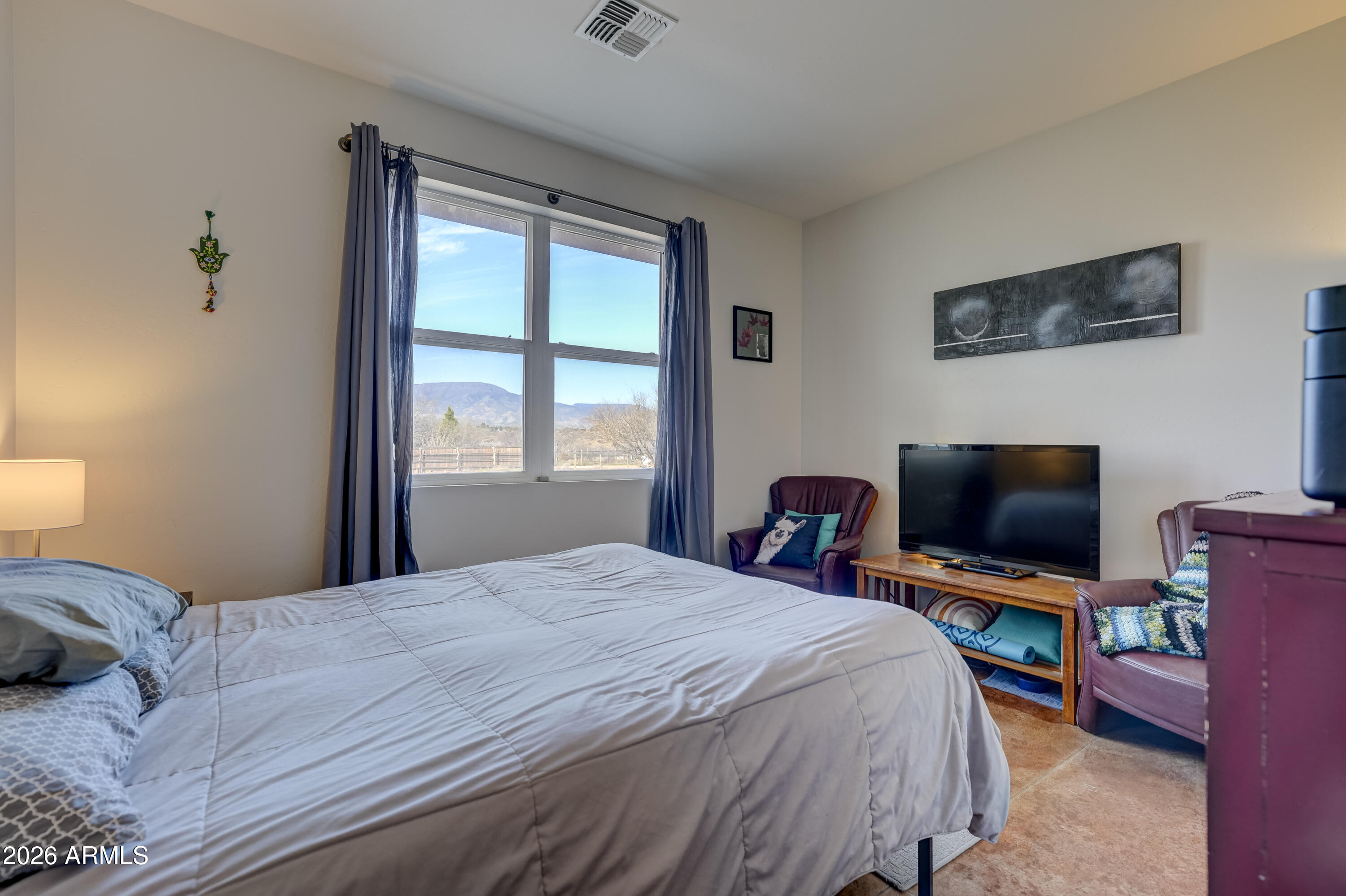 2771 South Country Hill Road Cornville, AZ 86325 - Photo 12 of 20 a bedroom with a bed and a flat screen tv
