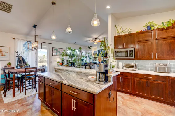 a kitchen with granite countertop a sink and cabinets