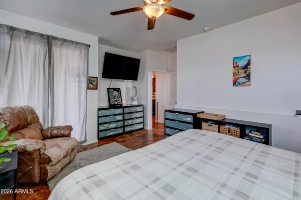 a bedroom with furniture and a flat screen tv