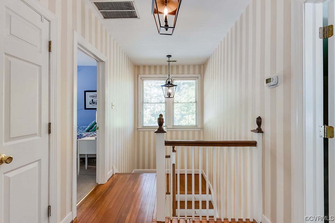5009 Devonshire Road Richmond, VA 23225 - Photo 17 of 43 a view of a hallway to a livingroom with wooden floor and windows