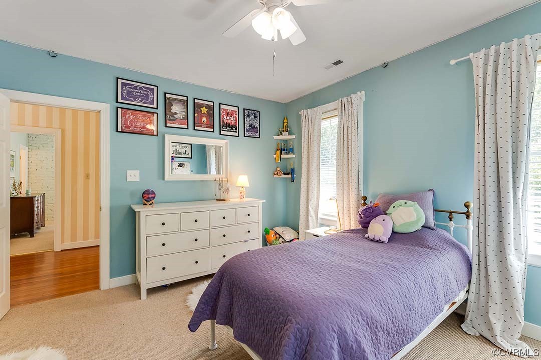 5009 Devonshire Road Richmond, VA 23225 - Photo 21 of 43 a bedroom with a bed and a chandelier