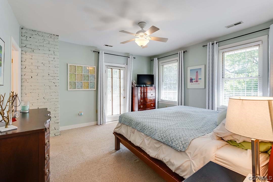 5009 Devonshire Road Richmond, VA 23225 - Photo 23 of 43 a spacious bedroom with a large bed and a chandelier