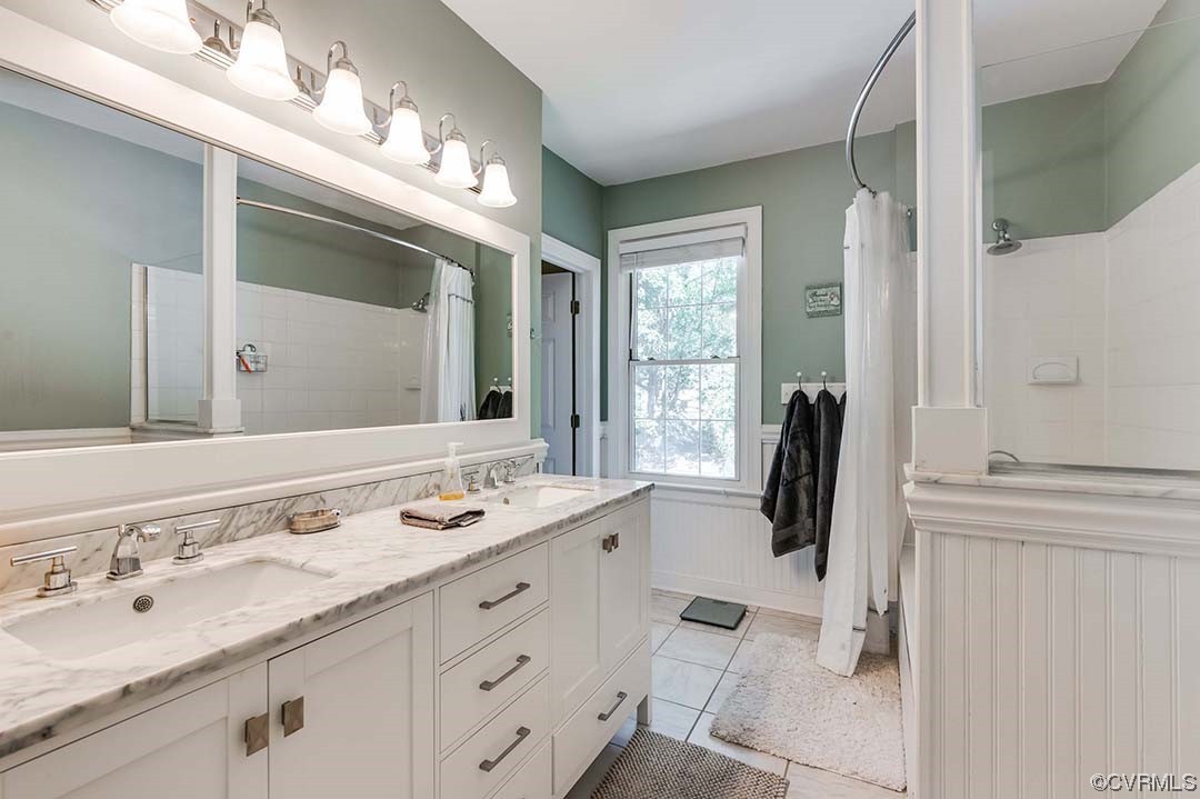 5009 Devonshire Road Richmond, VA 23225 - Photo 24 of 43 a bathroom with a granite countertop sink and a mirror