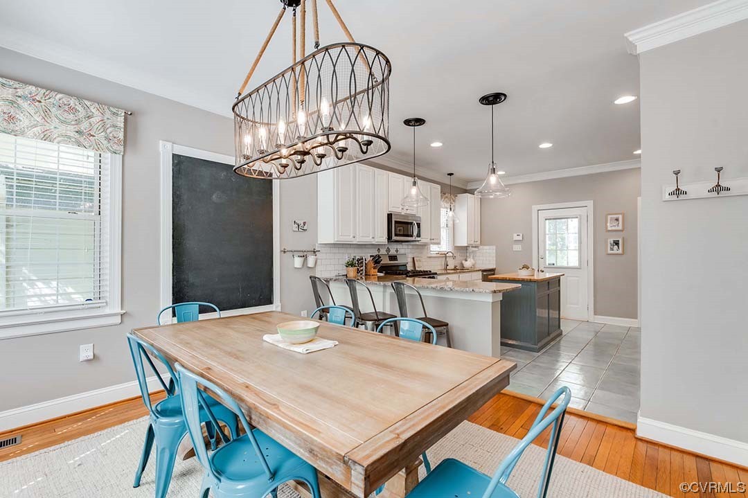 5009 Devonshire Road Richmond, VA 23225 - Photo 5 of 43 a kitchen with a table and chairs in it
