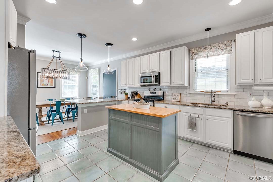 5009 Devonshire Road Richmond, VA 23225 - Photo 8 of 43 a kitchen with kitchen island granite countertop appliances cabinets and a sink