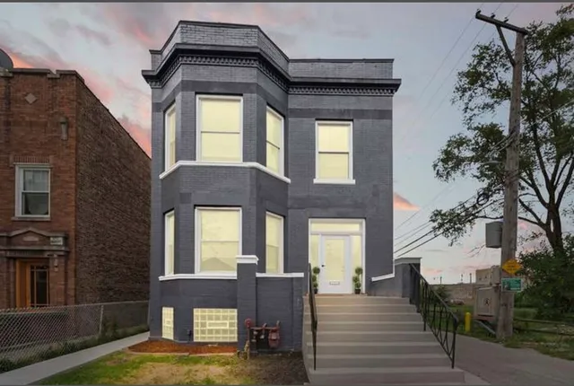 a view of a brick building with large windows