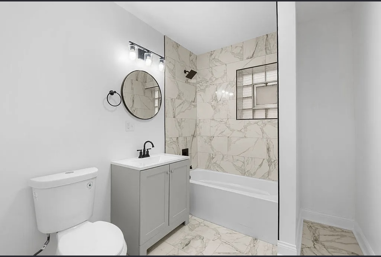7912 South Ada Street, Unit 1 Chicago, IL 60620 - Photo 6 of 10 a bathroom with a sink toilet and shower